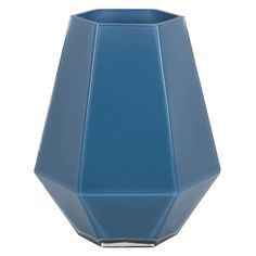 a blue vase sitting on top of a white table