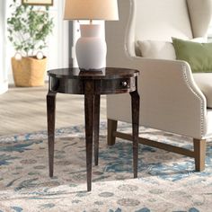 a living room scene with focus on the end table and lamp in the middle of the room