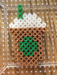 an object made out of plastic tubes on top of a wooden table