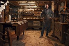 a man standing in an old fashioned shop