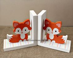 an open book with a paper cut out of the shape of a fox sitting on top of it