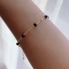 "* DETAILS * - 24K Gold Filled Chain - Black Spinel Faceted Rondelle Beads 3-4mm - 14K Gold Filled Wire - 14k Gold Filled Spring Ring Clasp - 14k Gold Filled Link Rings - Bracelet has a 1\" Extension ✨All components are gold filled. 👉🏻For more gemstone bracelets, see https://www.etsy.com/shop/JinnysJewelryBySeJin You may also like 🌟Sapphire Bracelet. https://www.etsy.com/JinnysJewelryBySeJin/listing/871033001/sapphire-14k-gold-filled-dainty-bracelet?utm_source=Copy&utm_medium=ListingManager&u Everyday Gold Bracelet With Black Beads, Elegant Black Bracelets In 14k Gold, Black Adjustable Elegant Gold Bracelet, Elegant Everyday Jewelry With Black Spinel, Black Spinel Jewelry, Black Spinel Bracelet, Tiny Bead Bracelet, Spinel Jewelry, Small Bead Bracelet