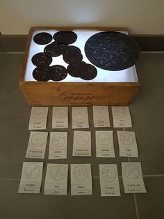 a wooden box filled with lots of black and white circles