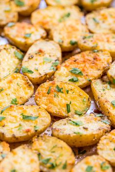 baked potato wedges with parsley on top, ready to be served in the oven