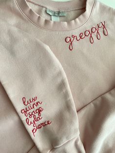 Grandma's favorite names hand stitched on the sleeve of our cozy fleece lined sweatshirts.    Sweatshirts are Unisex sizing and run true to size.  I suggest sizing up for a more oversized fit. 70/30 cotton/polyester 3-End fleece, ring spun cotton  Returns and Exchanges: I do not accept returns on personalized pieces but will be happy to discuss any issues via messages. Thanks for visiting Sweet Olive Street! Please check us out on Instagram for more behind the scenes @sweetolivestreet Pink Crew Sweatshirt With Embroidered Graphics, Cozy Long Sleeve Tops With Letter Embroidery, Pink Sweatshirt With Custom Embroidery In Relaxed Fit, Cozy Embroidered Long Sleeve Sweatshirt, Long Sleeve Fleece Top With Letter Embroidery, Fleece Top With Letter Embroidery And Long Sleeves, Cozy Long Sleeve Sweatshirt With Letter Embroidery, Pink Sweater With Custom Embroidery For Fall, Pink Winter Tops With Custom Embroidery