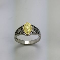 "The Mother Mary ring representing the miraculous medal made by the lost wax method in solid filigree style in Peruvian 925 Silver, in  a vintage style with an image of the Miraculous Virgin Mary, catholic ring with 14k gold Virgin Mary image, welded on the top as the main detail. Its approximate weight: 4.0 gr RING SIZE The ring is made to your personal size, just select a size that fits your finger. As it is a very careful work, please allow me a reasonable time to prepare your ring and make it to your entire satisfaction. I will send you immediately have your order ready. The ring is sent in a gift package and courtesy accompanying a cleaning wipe PAYMENT METHOD We accept PayPal payment process. However, to pay you do not need to be affiliated with Pay Pal. Contact us if you wish to cho Spiritual Oval Ring With Intricate Design, Spiritual Oval Rings With Intricate Design, Spiritual Sterling Silver Rings With Intricate Design, White Gold Miraculous Medal Jewelry In Sterling Silver, Spiritual Filigree Ring Jewelry, Sterling Silver Filigree Ring With Polished Finish As Gift, Gold Filigree Ring In Sterling Silver, Sterling Silver Rings With Intricate Design In Yellow Gold, Yellow Gold Sterling Silver Rings With Intricate Design