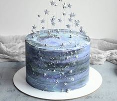 a blue cake with silver stars on top