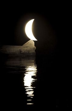 the moon is reflected in the water at night