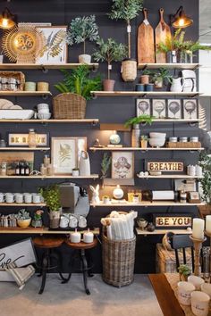 a room filled with lots of shelves covered in different types of plants and decor items