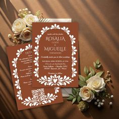 an orange and white wedding suite with flowers on the table next to it, including roses