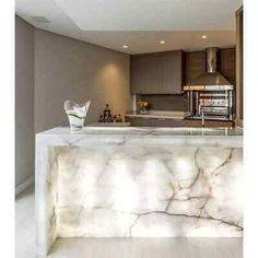 a kitchen with marble counter tops and cabinets