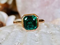 This classic bezel mounting contains a beautiful 2.00 ct. asscher cut lab created emerald. The stone measures approximately 8x8mm. The ring is available in sterling silver, and 14k white, yellow, or rose gold. Please send me a message if you need a size not listed. * This ring can be customized with any color center stone and is available with a matching band. All items are handmade by me in my shop in Woodbridge, NJ. Please message me with any questions. Shipping within the United States is com Elegant Asscher Cut Emerald Ring With Bezel Setting, Formal Octagon Emerald Ring With Bezel Setting, Classic Emerald Ring With Asscher Cut And Bezel Setting, Fine Jewelry Octagon Emerald Ring With Bezel Setting, Asscher Cut Emerald Ring With Center Stone As Gift, Emerald Solitaire Jewelry In Asscher Cut, Gift Emerald Ring With Radiant Cut And Bezel Setting, Asscher Cut Emerald Promise Ring, Octagon Solitaire Emerald Ring