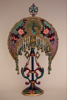 an elaborately decorated lamp on a stand