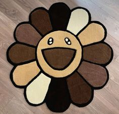 a brown and white rug with a smiling face on it's center piece in the floor