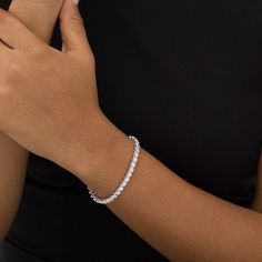 Take your look from ready to resplendent with this timeless yet dazzling diamond tennis bracelet. Crafted in cool 10K white gold Glistening 1/10 ct. diamonds create this stunning line of sparkle. Breathtaking with 5 cts. t.w. of diamonds This 7.0-inch bracelet secures with a tongue and groove clasp. Tennis Diamond Bracelet, Tennis Bracelet Aesthetic, Diamond Bracelets Women, Ig Fits, Travel Editorial, Future Jewelry, December Jewelry, Mens Bling, Gold Grillz