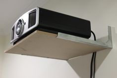 a projector mounted to the side of a wall