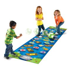 three children playing on a play mat