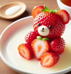 a small teddy bear made out of strawberries on a plate