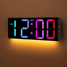 a digital clock with the time displayed in red, blue and green colors on a brown background