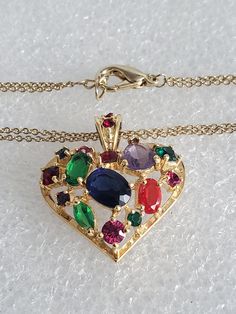 "If you are searching for the perfect Valentine's Day gift than you come to the right place. Presented here is a multi-colored glass heart pendant necklace that is strung onto a double curb chain. Both pieces are made in a gold tone base metal with no hallmark. The heart pendant has an open back where you can see the colored stones. The bale also has 2 small red stones and is big enough for any type of chain. Both pieces are vintage and are in excellent condition and will arrive in a gift box wi Multicolor Pendant Jewelry For Birthday, Multicolor Heart Charm Jewelry For Anniversary, Multicolor Heart Charm Necklace For Anniversary, Multicolor Jewelry Valentine's Day Gift, Multicolor Jewelry For Valentine's Day Gift, Colorful Heart Beads Jewelry As A Gift, Colorful Heart Bead Jewelry For Gifts, Colorful Heart Beads Jewelry As Gift, Valentine's Day Multicolor Jewelry Gift