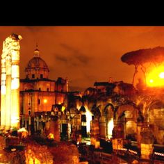 an image of a city at night with the lights on and buildings lit up in the background