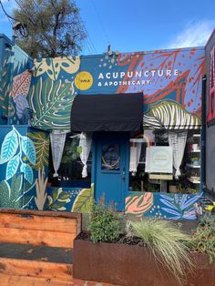 the front of an artisan shop painted with flowers and leaves