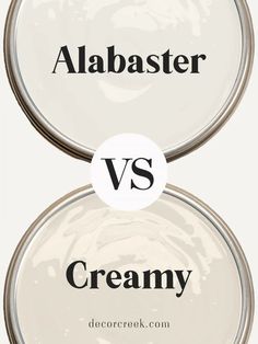 The image displays a comparison between two paint colors, "Alabaster" and "Creamy." Both color names are placed inside the outline of paint cans, with "Alabaster" at the top and "Creamy" at the bottom. In the center, there is a large "VS" inside a circle, indicating a contrast between the two shades. The background shows a soft, neutral palette, highlighting the subtle differences between these two off-white colors. Alabaster Paint Scheme, Beige Paint Colors, Alabaster Color, Cozy Interiors, Beige Paint, Popular Paint Colors, Favorite Paint Colors, Paint Colors Benjamin Moore