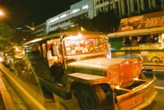 an old jeep is parked on the side of the road in front of other vehicles