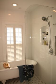 a white bath tub sitting next to a window