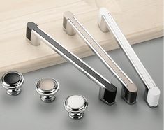 an assortment of knobs and handles on a gray surface