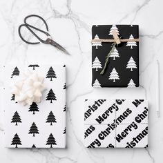 wrapping presents with black and white christmas trees