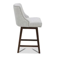 a white upholstered bar stool with wooden legs