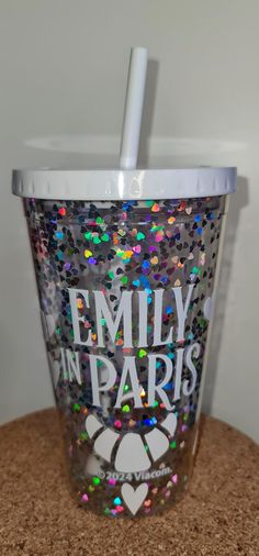 a cup with the words family in paris on it and a straw sticking out of it