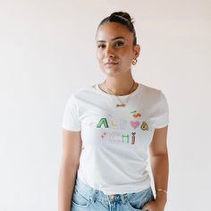 a young woman is standing in front of a white wall wearing a t - shirt that says happy girl