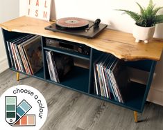 a record player is sitting on top of a shelf with vinyl records in front of it