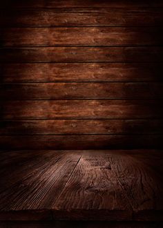 an empty wooden room with dark wood flooring and lighting on the wall behind it