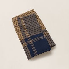 a blue and brown plaid pocket square on a white surface