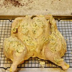 a whole chicken sitting on top of a metal rack