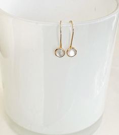 These simple, beautiful earrings are dainty but and versatile enough to be worn everyday.    They feature a 6mm white mother of pearl cabochon set in a 14kt gold filled bezel.  The ear wire is hand forged from 14kt gold filled wire.  The stone dangles about 1/2" below the earlobe. Minimalist 14k White Gold Earrings, Delicate White Pearl Earrings For Everyday, Minimalist 14k Gold Pearl Earrings For Everyday, Delicate White 14k Gold Filled Earrings, Minimalist White Pearl Earrings In 14k Gold Filled, Minimalist White Pearl Earrings 14k Gold Filled, White 14k Gold Filled Pearl Earrings, Everyday Minimalist 14k Gold Pearl Earrings, Minimalist White 14k Gold Filled Pearl Earrings