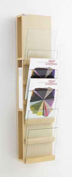 a book shelf with three different colored umbrellas hanging on it's sides,