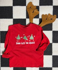 "Looking for a fun and festive t-shirt for your little one this Christmas? Look no further than our \"Too Lit To Quit\" Christmas tree tee! Perfect for kids who love the magic and excitement of the holiday season, this retro themed shirt is sure to bring a smile to everyone's face. Made from soft and comfortable material, it features a bold and playful design that is sure to stand out in any crowd. So why wait? Get your child(ren) and family ready for Christmas in style with our fun tee today!  All items are made to order in the order in which they are received so please allow up to 7 business days for your order to be shipped out. We will always try to get orders out as fast as possible. :)  **If you need your order delivered by a certain date please leave a note in the notes to seller** Holidays With Toddlers, Funny Holiday Shirts, Christmas Shirts For Kids, Christmas Look, Tee Tree, Ready For Christmas, Funny Christmas Shirts, Kids Graphic Tees, Shirts Funny