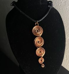 Handmade and adjustable length spiral pendant necklace. Adjustable Choker Necklace With Large Pendant, Elegant Adjustable Swirl Necklace, Adjustable Wire Wrapped Metal Necklaces, Adjustable Spiral Wire Wrapped Jewelry, Unique Adjustable Cord Choker Necklace, Handmade Adjustable Swirl Jewelry, Spiral Adjustable Necklace As Gift, Adjustable Spiral Necklace As Gift, Adjustable Spiral Necklace For Gifts