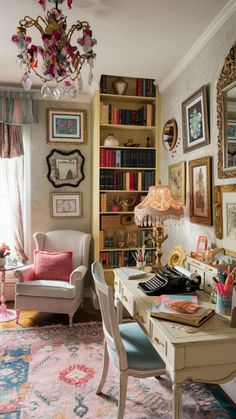 a home office with lots of bookshelves and pictures on the wall