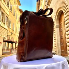 This Italian leather Backpack is a true masterpiece of craftsmanship. Handmade in Florence, Italy, it combines luxurious materials and exquisite attention to detail. Elevate your style and travel in sophistication with this elegant backpack. . Size: Height 44cm/17.4 inch Width 32cm/12.6 inch Depth 12cm/4.8 inch . The story of this backpack: In the vibrant city of Florence, Italy, a small artisan workshop nestled amidst the cobblestone streets hummed with creativity and passion. Here, a skilled craftsman named Alessio dedicated himself to the art of crafting exquisite handmade leather goods. His attention to detail and commitment to quality resulted in remarkable creations, including a collection of leather backpacks that were both functional and stylish. One day, a young student named Marc Luxury Leather Backpack For Travel In Cognac, Luxury Cognac Leather Backpack For Travel, Luxury Cognac Leather Travel Backpack, Luxury Formal Satchel Backpack, Elegant Rectangular Backpack, Elegant Business Satchel Backpack, Luxury Business Backpack Shoulder Bag, Classic Backpack As Gift, Luxury Leather Backpack For Formal Occasions