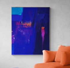 a living room with an orange couch and blue painting on the wall above it,