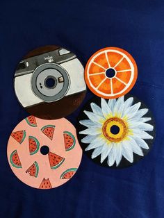 three different items are displayed on a blue surface with one orange and the other watermelon