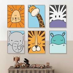 four children's wall art prints in various colors and sizes, including zebra, giraffe, lion, elephant