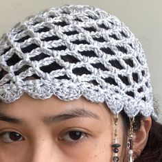 a close up of a person wearing a crochet hat