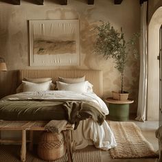 a bedroom with a bed, rugs and pictures on the wall above it in neutral colors