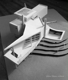 an architectural model of a house on top of a piece of paper